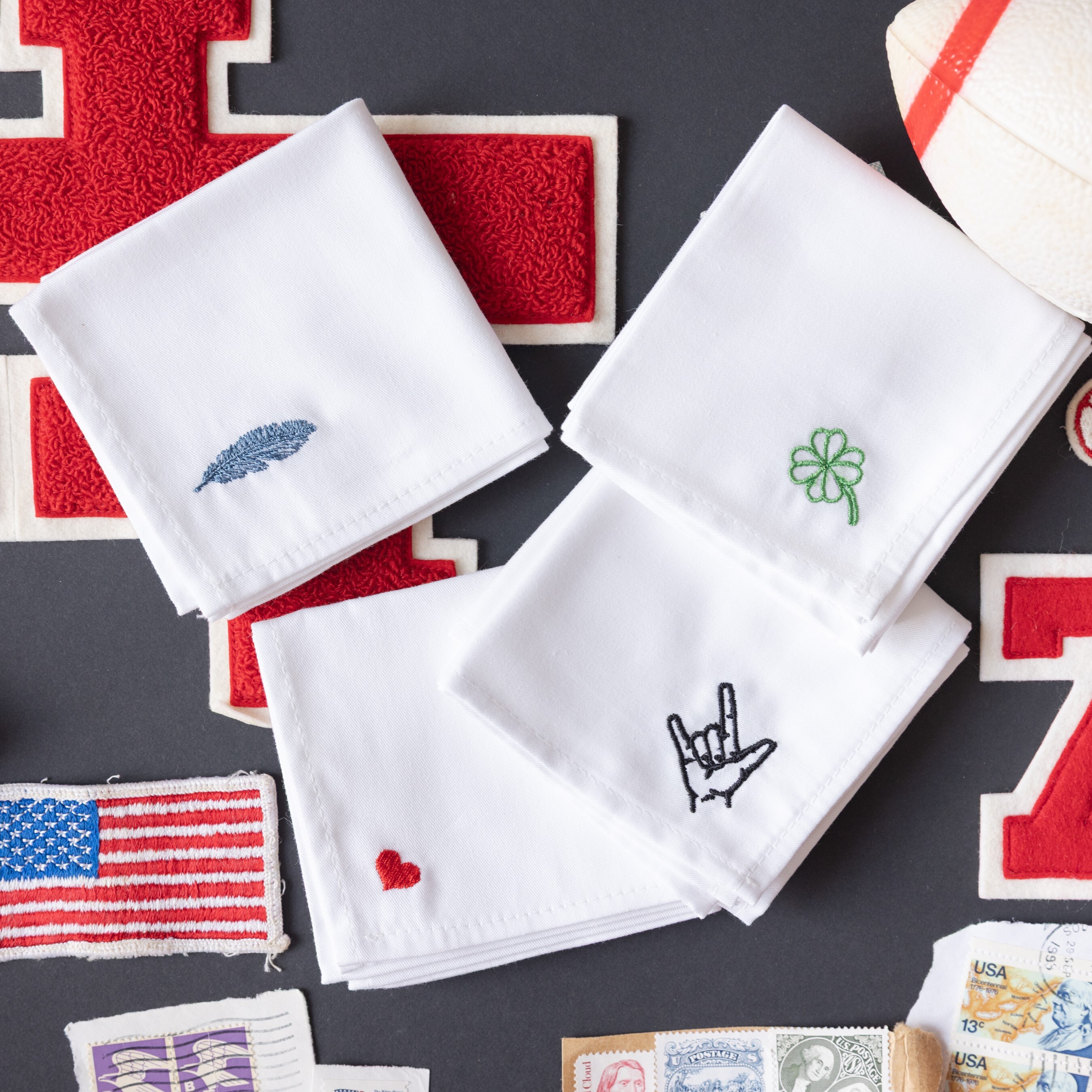 Embroidered monogrammed handkerchiefs with hearts, shamrock, feather.